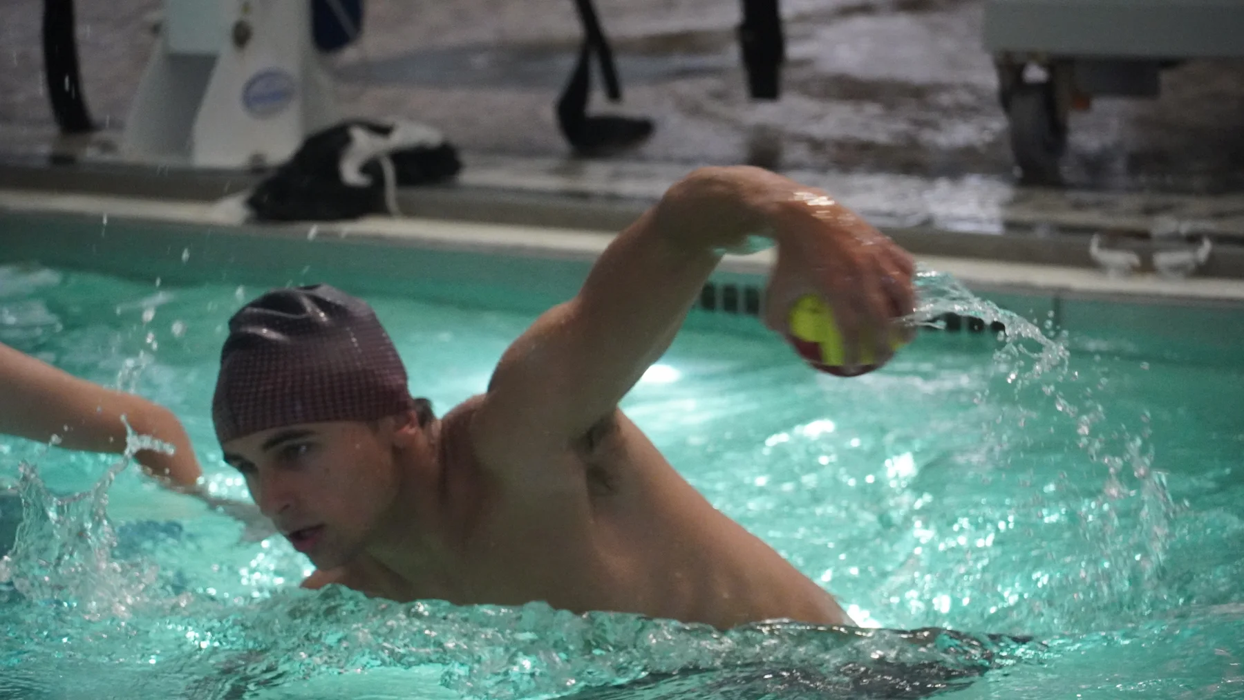 A Railball player raises the ball above the water, ready to throw.